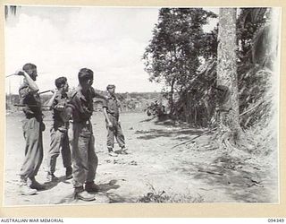 ULEBILUM, YAMIL AREA, NEW GUINEA, 1945-07-16. MEMBERS OF PIONEER PLATOON, 2/5 INFANTRY BATTALION, THROWING BAYONETS USING A CAPTURED JAPANESE FLAG AS A TARGET