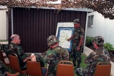 Army CHIEF of STAFF General (GEN) Carl E. Vuono, left, listens to a briefing by Colonel Edward T. Tiexeira, deputy commander of the training area. Vuono is visiting the training area to observe elements of the 25th Infantry Division (Light), undergoing tr