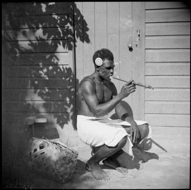 Asavia [?] smoking a traditional bamboo pipe, Malaguna Road, Rabaul, New Guinea, ca. 1936, 2 / Sarah Chinnery