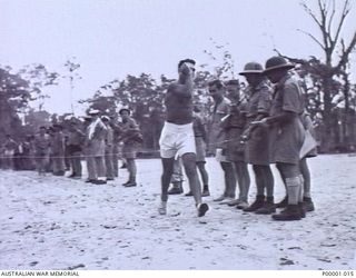 THE SOLOMON ISLANDS, 1945-01-12. A SERVICEMAN COMPLETING ONE OF THE FIELD EVENTS AT A COMBINED ANZAC SPORTS MEETING AT BOUGAINVILLE ISLAND. (RNZAF OFFICIAL PHOTOGRAPH.)