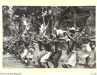 SONG RIVER, FINSCHHAFEN AREA, NEW GUINEA. 1944-03-26. RABAUL BOYS TAKING PART IN A NATIVE SING-SING IN THE AUSTRALIAN NEW GUINEA ADMINISTRATIVE UNIT COMPOUND TO CELEBRATE THE RE OCCUPATION OF THE ..