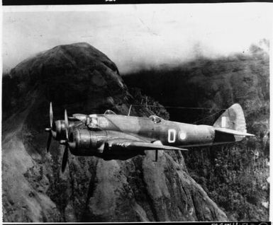 Beaufighter of 30 Squadron RAAF flying by Hombrom's Bluff near Port Moresby, Papua New Guinea, 1942 / [W.B. Ball]