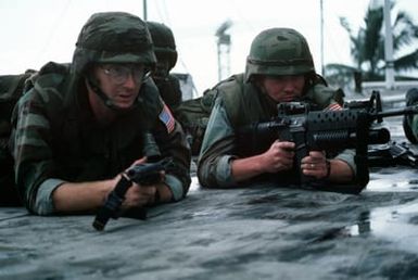 A group of Marines stand watch on the roof of the United States Embassy. Marines of the 22nd Marine Expeditionary Unit (22nd MEU), deployed aboard the amphibious assault ship USS SAIPAN (LHA 2), were sent to augment security at the embassy as part of Operation SHARP EDGE