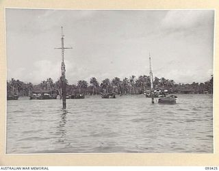 AITAPE BEACH HEAD, NEW GUINEA. 1945-06-19. THE BEACH HEAD, TAKEN OUT FROM THE BEACH, SHOWING LANDING CRAFT TANKS BEACHED WHILE BEING LOADED WITH STORES FOR WEWAK BY MEMBERS OF 7 DOCKS OPERATING ..