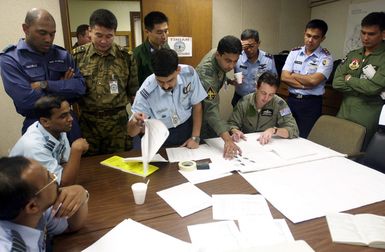 Squadron Leaders and Commanders of participating countries discuss events and scenarios that will take place on the flightline of Andersen AFB, Guam during the PACIFIC AIRLIFT RALLY 2001. PACIFIC AIRLIFT RALLY (PAR) is a PACAF-sponsored Military Airlift symposium for countries in the pacific region. PAR, held every two years and hosted by a pacific nation, this year Guam is the host nation with the symposium staging out of Andersen AFB. The symposium includes informational seminars with area of expertise briefings, a Command Post Exercise (CPX) which addresses military airlift support to a humanitarian airlift/disaster relief scenario, and a concurrent flying training program that builds...