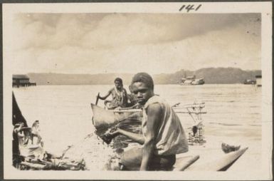 Men in canoes with their produce for sale, Rabaul, New Britain Island, Papua New Guinea, probably 1916