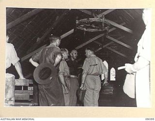 JACQUINOT BAY, NEW BRITAIN. 1945-04-08. SENATOR J.M. FRASER, ACTING MINISTER FOR THE ARMY (1), AND SENIOR OFFICERS EXAMINING THE INTERIOR OF THE CHAPEL AT 105 CASUALTY CLEARING STATION WHICH WAS ..