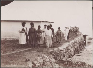 Melanesian women on pier during a visit to Vila, New Hebrides, 1906 / J.W. Beattie