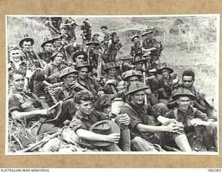 RAMU VALLEY AREA, NEW GUINEA, 1943-11-08. MEMBERS OF D COMPANY, 2/27TH AUSTRALIAN INFANTRY BATTALION HAVING A SPELL DURING THEIR TREK FROM GUY'S POST. THEY ARE: UNKNOWN (1); PRIVATE BOWLES (2); ..