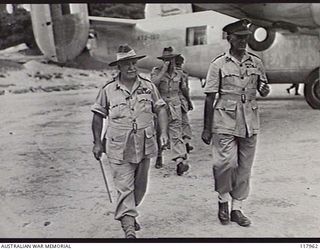 TOROKINA, BOUGAINVILLE. 1945-10-29. GENERAL SIR THOMAS A. BLAMEY, COMMANDER IN CHIEF, AUSTRALIAN MILITARY FORCES, ACCOMPANIED BY MAJOR GENERAL W. BRIDGEFORD, GENERAL OFFICER COMMANDING, MOVING TO ..