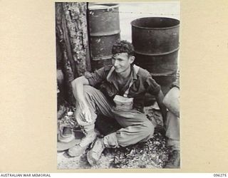 JACQUINOT BAY, NEW BRITAIN. 1945-09-09. SAPPER J. DUMAS, 13 FIELD COMPANY, ROYAL AUSTRALIAN ENGINEERS, A MEMBER OF THE FORCE WAITING FOR EMBARKATION ON HMAS MANOORA. THE MANOORA CARRIED TROOPS FOR ..