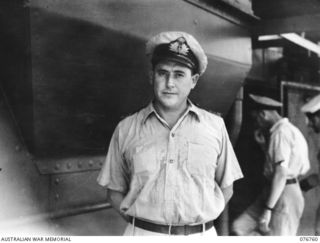 MADANG, NEW GUINEA. 1944-10-26. LIEUTENANT-COMMANDER D. LOGAN, RAN, COMMANDER OF THE CORVETTE LATROBE ABOARD THE FRIGATE, HMAS BARCOO