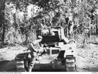 BOUGAINVILLE, 1945-07-11. LANCE-CORPORAL R.J. CHAMBERS (1), AND CORPORAL J. STOPFORD (2), MEMBERS OF A SQUADRON, 2/4 ARMOURED REGIMENT ATTACHED 3 DIVISION, INSPECTING A MATILDA TANK THAT WAS ..