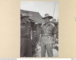 CAPE WOM, NEW GUINEA. 1945-11-14. CAPTAIN A.W. STRONG, OFFICER COMMANDING 6 DIVISION PROVOST COMPANY (1) AND LIEUTENANT J. LAVER, SECOND IN COMMAND (2)