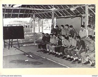 YALU, NEW GUINEA. 1945-08-03. SAND TABLE EXERCISES IN BATTLE PROCEDURE TAKING PLACE IN THE GENERAL WING OF THE NEW GUINEA TRAINING SCHOOL