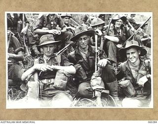 RAMU VALLEY AREA, NEW GUINEA. 1943-11-08. TROOPS OF THE 2/27TH AUSTRALIAN INFANTRY BATTALION ENJOY A SPELL DURING THEIR MARCH FROM GUY'S POST. SHOWN ARE: SX17414 LANCE CORPORAL A. J. CHELLEW OF ..