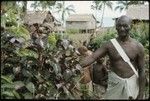 Man with branches of bush