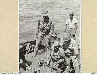 9TH AUSTRALIAN DIVISION, UNDER THE COMMAND OF NX7 MAJOR-GENERAL G.F. WOOTTEN, CBE, DSO, ED, IN THE FIRST AUSTRALIAN AMPHIBIOUS OPERATION SINCE GALLIPOLI, LANDS AT LAE. ADMIRAL BARBEY (2 STARS ON ..