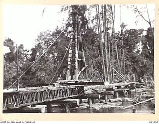 BOUGAINVILLE, 1945-06-18. SAPPERS OF 3 PLATOON, 23 FIELD COMPANY, ROYAL AUSTRALIAN ENGINEERS, WORKING ON A BRIDGE OVER MAMAREQU LAGOON, NEAR MOTUPENA POINT