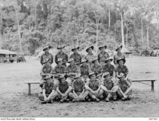 Group portrait of members of 9 Platoon, A Company, 58/59 Infantry Battalion. Identified, back row, left to right: Private (Pte) A Hamilton; Pte K P Macrae; Pte E Evans; Pte G Heard; Pte L Sait; Pte ..