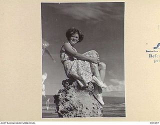 LAE, NEW GUINEA, 1945-05-18. CORPORAL M. WALLACE, AUSTRALIAN WOMEN'S ARMY SERVICE BARRACKS, SUNBATHING ON A ROCK NEAR MALAHANG BEACH WHILE TAKING PART IN A TOUR OF THE AREA CONDUCTED BY ARMY ..