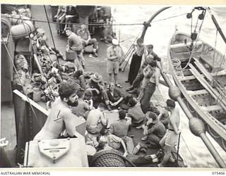 AT SEA. 1944-08-20. TROOPS OF THE 25TH INFANTRY BATTALION ENJOYING A GAME OF CARDS ABOARD THE FRIGATE, HMAS "BARCOO" WHILE ON THEIR WAY FROM SIAR TO POTSDAM