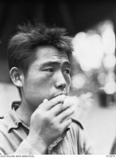 DUMPU, NEW GUINEA. 1944-04-19. ONE OF FOUR JAPANESE PRISONERS OF WAR AWAITING INTERROGATION BY INTELLIGENCE OFFICERS AT HEADQUARTERS 11TH DIVISION. THE PRISONERS, CAPTURED AT NAP NAP ON THE WANTOAT ..