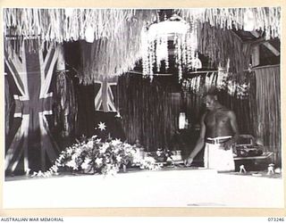 LAE, NEW GUINEA. 1944-05-20. THE DECORATED MESS OF THE SUPPLY AND STORES SECTION, HEADQUARTERS NORTHERN REGION, AUSTRALIAN NEW GUINEA ADMINISTRATIVE UNIT. TOKANINI, A NATIVE FROM MATUPI VILLAGE, ..