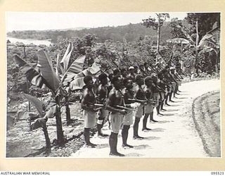 WUNUNG, JACQUINOT BAY, NEW BRITAIN, 1945-08-25. ALLIED INTELLIGENCE BUREAU NATIVE SOLDIERS ON PARADE AT THEIR HEADQUARTERS