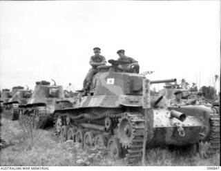 RAPOPO AIRSTRIP, NEW BRITAIN, 1945-09-19. OFFICERS OF 2/4 ARMOURED REGIMENT SITTING ON A JAPANESE TYPE 97 CHI-HA MEDIUM TANK WHICH BEARS THE INSIGNIA OF A JAPANESE COMMANDING OFFICER. FOLLOWING THE ..