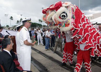 U.S. Navy Rear Adm. T. G. Alexander, Commander, Navy Region Hawaii, prepares to make an offering during a Lion Dance following the arrival of two Chinese Peoples Liberation Army Navy ships, the Luhu Class (Type 052) Guided Missile Destroyer QINGDAO (DDG 113) and the Fuquing Class Replenishment Ship HONGZEHU (AOR 881) at Naval Station Pearl Harbor, Hawaii, for a three-day Goodwill Visit on Sept. 6, 2006. The visit provides an excellent opportunity to enhance cooperation between the two navies and underscores the United States commitment to supporting ongoing cooperative efforts in the Pacific Region. (U.S. Navy photo by CHIEF Mass Communication SPECIALIST David Rush) (Released)