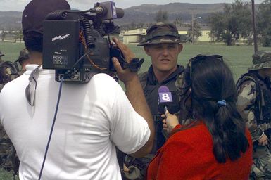 Private First Class Robert C. Thornton from the 31st Marine Expeditionary Unit's (MEU) security platoon talks with a local television crew during the media day held for Training in an Urban Environment Exercise (TRUEX) 99-2. The training is conducted to prepare 31st MEU Marines on the unique situations encountered when operating in urban environments and performing missions including non-combatant evacuations, humanitarian assistance and show-of-force operations