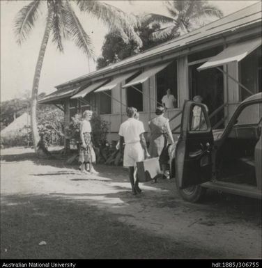 Women welcoming newcomer with suitcase