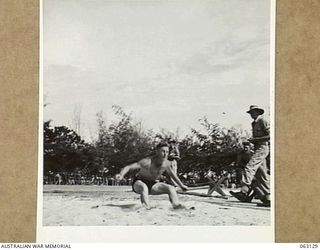 ELA BEACH, NEW GUINEA. 1944-01-01. NX23913 SERGEANT J. G. MASON OF THE ROYAL AUSTRALIAN ARTILLERY CLEARING 19' 11" IN THE BROAD JUMP EVENT AT THE ALLIED SERVICES GRAND SPORTS CARNIVAL