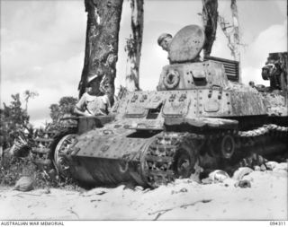 Cape Boram, Wewak area, New Guinea.  Personnel examining an armoured recovery variant of the medium type 97 Chi Ha tank, which was captured on the beach.  Army workshops, the tank regiments and the ..