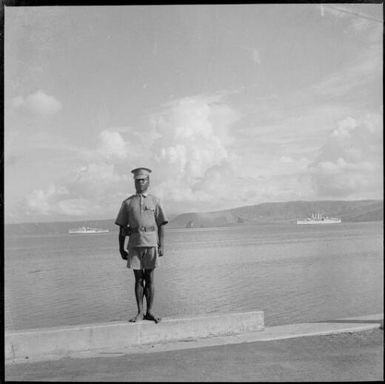 Policeman in uniform and HMAS Australia [?], Rabaul Harbour, New Guinea, 1937 / Sarah Chinnery