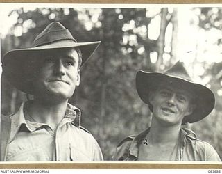 GUY'S POST, NEW GUINEA. 1944-01-10. QX39291 PRIVATE E. E. EWAN (1) AND QX37570 PRIVATE S. G. HOWARD (2) OF NO. 10 PLATOON, 2/9TH INFANTRY BATTALION RESTING AT GUY'S POST