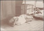 A Melanesian boy asleep on the deck of the Southern Cross, 1906 / J.W. Beattie