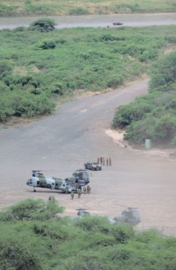 Two CH-46E Sea Knight helicopters from Marine Medium Helicopter Squadron 265 (HMM-265) take on troops and equipment at a landing zone on the station. The helicopters and troops are participating in Exercise RimPac '88