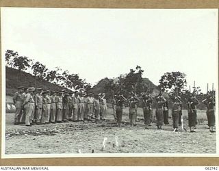 BOMANA WAR CEMETERY, PAPUA, NEW GUINEA. 1943-12-29. AT THE CONCLUSION OF A MEMORIAL SERVICE CONDUCTED BY CHAPLAIN J. D. MCKIE, CHURCH OF ENGLAND, A FIRING PARTY IN CHARGE OF QX226 SERGEANT N. L. ..