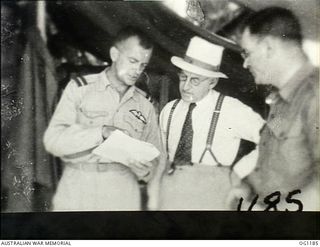 AITAPE, NORTH EAST NEW GUINEA. C. 1944-06. AT HEADQUARTERS NO. 10 GROUP RAAF, LEFT TO RIGHT: AIR COMMODORE F. R. W. SCHERGER, THE AIR OFFICER COMMANDING NO. 10 GROUP RAAF, ARTHUR DRAKEFORD, THE ..