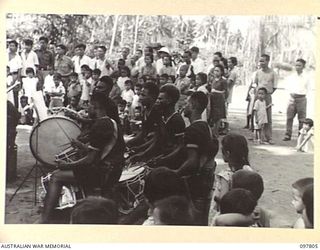 RATONGOR, NEW BRITAIN. 1945-10-10. THE SIDE DRUM SECTION OF THE ROYAL PAPUAN CONSTABULARY BAND PLAYING FOR THE GALA DAY CELEBRATIONS HELD AT THE CHINESE INTERNMENT CAMP, TO MARK THE 34TH ..