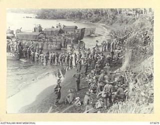 SARANG HARBOUR, NEW GUINEA. 1944-05-31. TROOPS AND STORES OF THE 37/52ND INFANTRY BATTALION UNLOADING FROM AMERICAN LANDING BARGES. THE AREA WAS USED AS A FORWARD BASE IN PREPARATIONS FOR THE BEACH ..