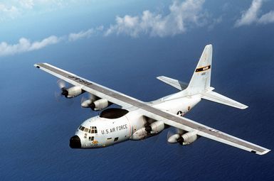 An air-to-air left front view of a WC-130 Hercules aircraft from the 54th Weather Reconnaissance Squadron on a mission to monitor and relay vital information on a typhoon to the Joint Typhoon Warning Center (JTWC)