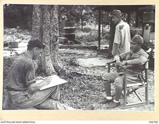 BUKA ISLAND, BOUGAINVILLE AREA, 1945-09-19. LIEUTENANT W.W. ROWED, OFFICIAL WAR ARTIST, MAKING A PENCIL SKETCH OF JAPANESE NAVAL OFFICER. THE ARTIST ACCOMPANIED THE AUSTRALIAN SURRENDER PARTY FROM ..
