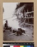 Woman cooking outdoors, Delena, Papua New Guinea, ca. 1905-1915