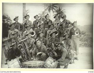 STIRLING ISLAND, TREASURY GROUP. 1945-03-21. THE 7TH INFANTRY BATTALION BAND. THE BAND MASTER, VX13065 SERGEANT M. DAVIS, WAS FOR SOME TIME WITH THE MILDURA BAND, IN VICTORIA, AND HAS CONDUCTED THE ..