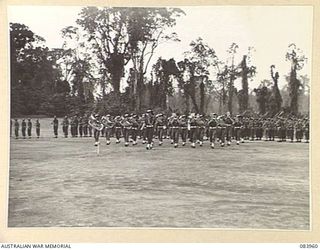 TOROKINA, BOUGAINVILLE, SOLOMON ISLANDS. 1944-12-15. THE BRIGADE BAND WHEELING INTO POSITION TO PLAY DURING THE MARCH PAST AT HEADQUARTERS 29 INFANTRY BRIGADE. 47 INFANTRY BATTALION TROOPS, (LESS C ..