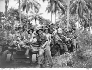 GODOWA, NEW GUINEA. 1943-11-05. TROOPS OF THE 2/6TH AUSTRALIAN FIELD REGIMENT RESTING ON THEIR JEEP AND SHORT 25 POUNDER WHILE AWAITING ORDERS TO MOVE ON. SHOWN ARE: NX98795 GUNNER J.P. ROACH (1); ..