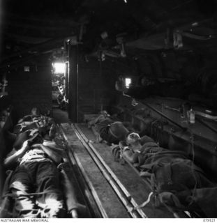 LAE, NEW GUINEA. 1943-11. A DOUGLAS C47 DAKOTA AIR AMBULANCE WITH STRETCHER PATIENTS IN THE RACKS FOR TRANSPORT SOUTH